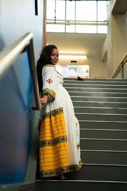 Portrait in Ethiopian dress on a staircase by Hailsh Creative